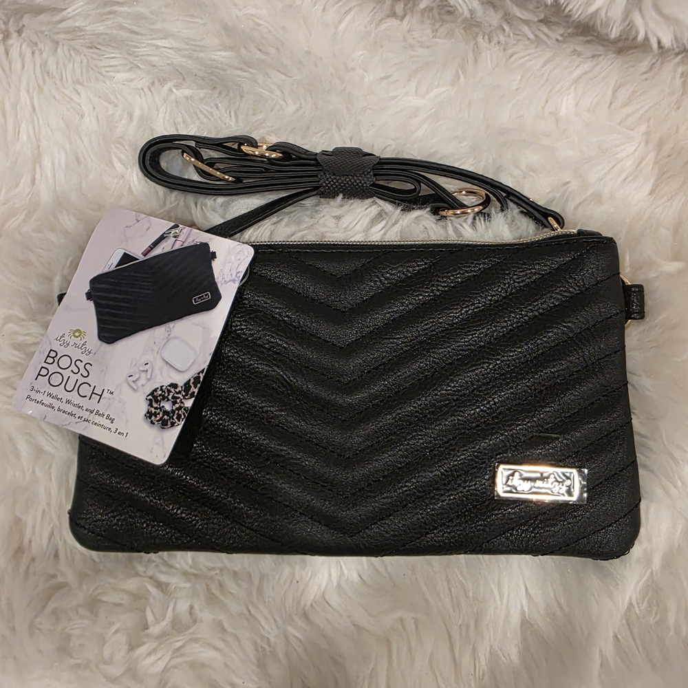 The Itzy Ritzy Boss Pouch is available in black and brown with white, and is des